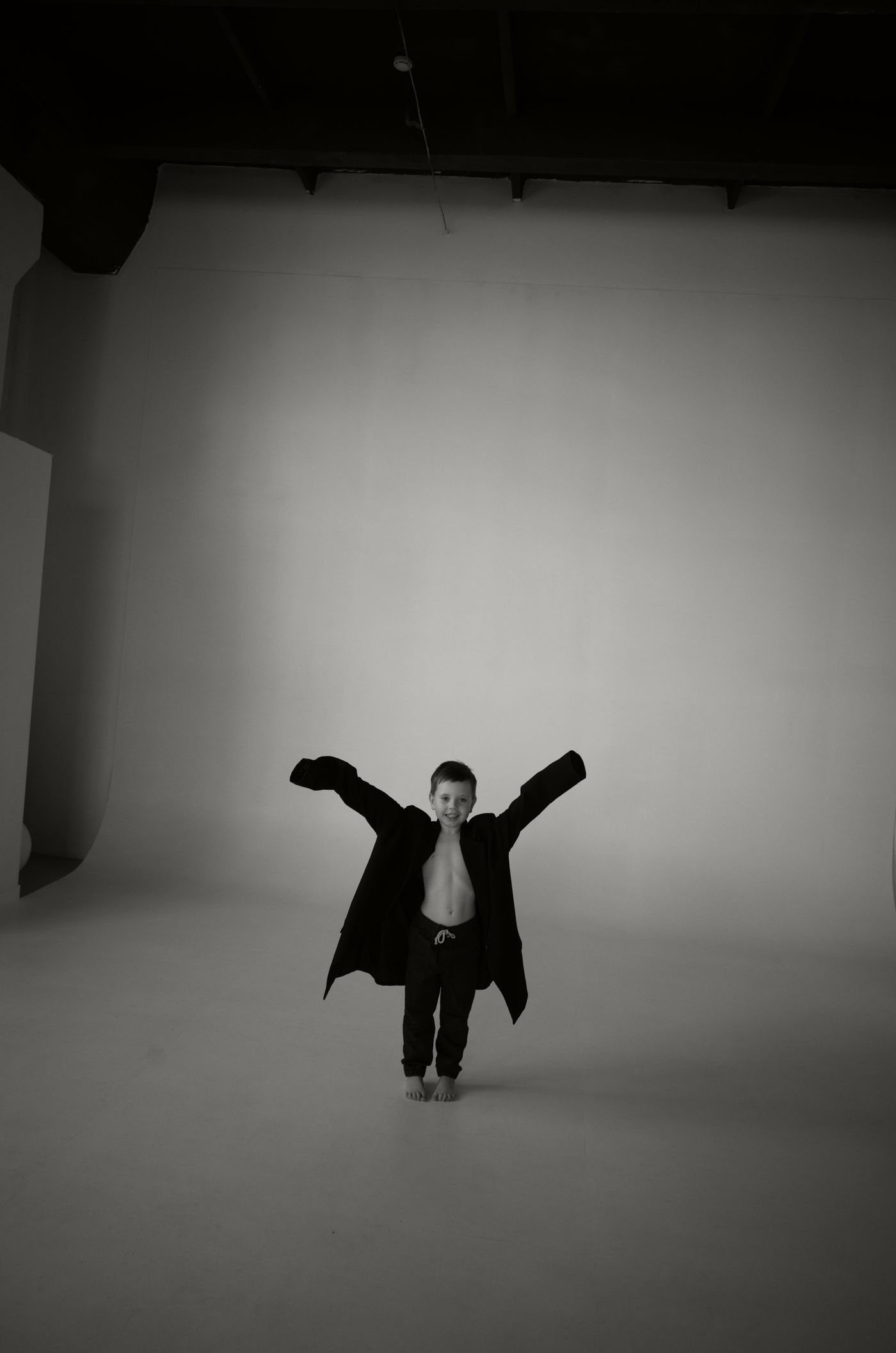 A child in an oversized jacket, a reminder of the potential to grow into something bigger